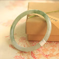 Green jade student bracelet with geometric beads showing Chinese style design and adjustable sizing options