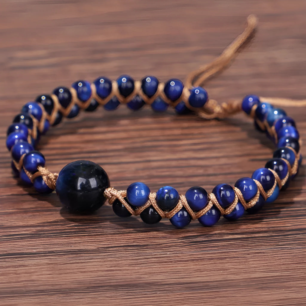 Close-up of a blue Tigereye hand-woven bracelet with a geometric pattern and pull closure.
