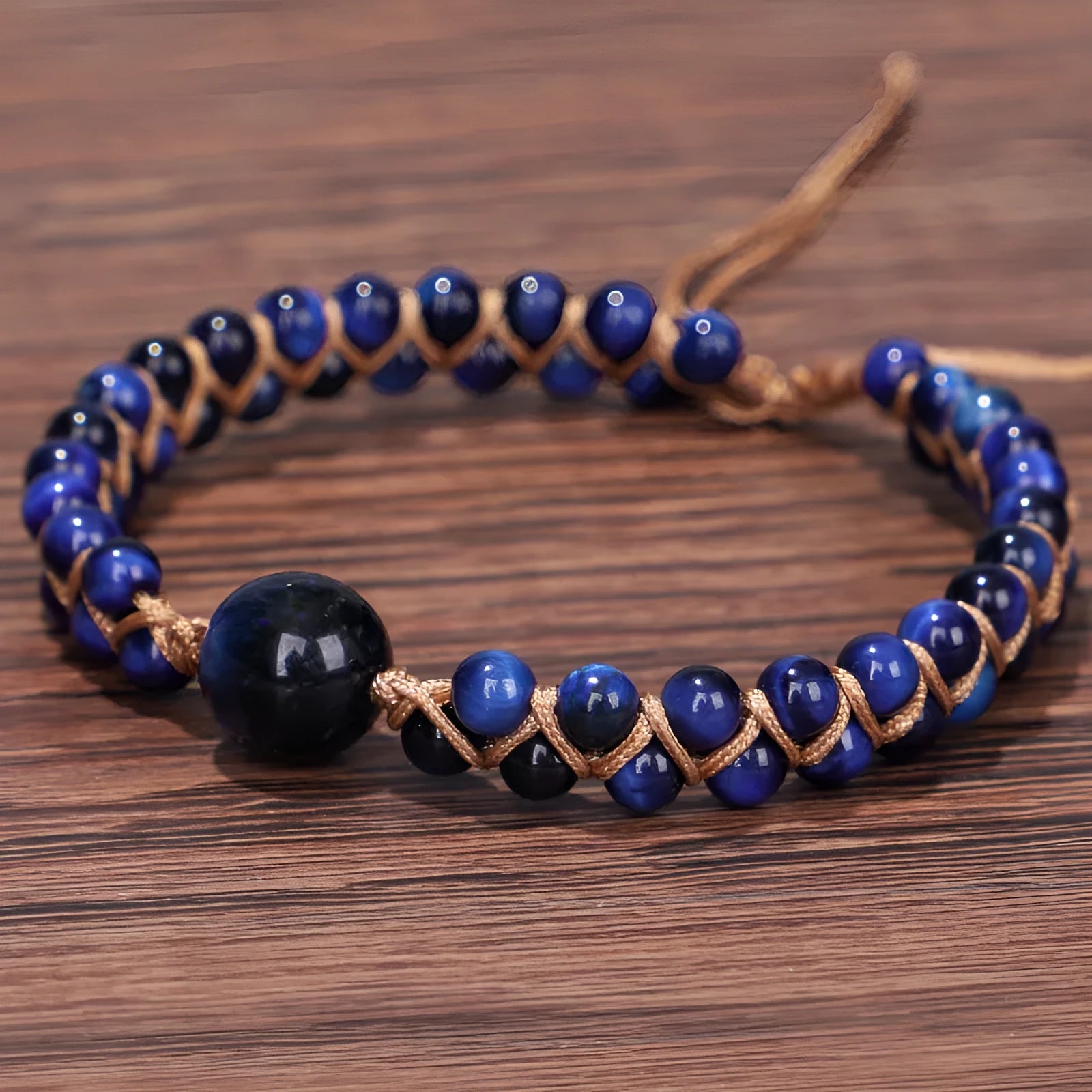Close-up of a blue Tigereye hand-woven bracelet with a geometric pattern and pull closure.