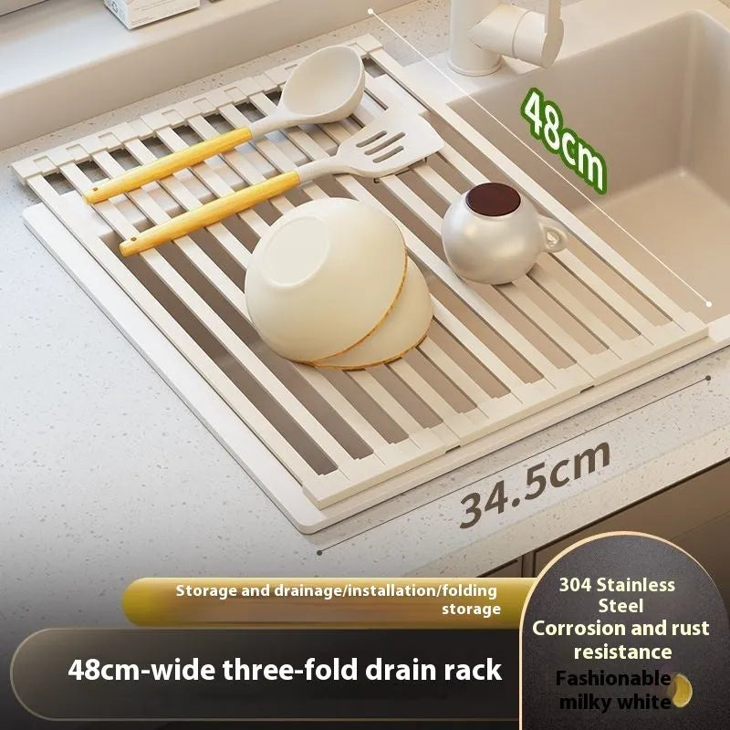 Foldable milky white stainless steel kitchen draining rack beside a sink
