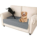 Dark grey and light grey double-sided waterproof dog cushion on a sofa