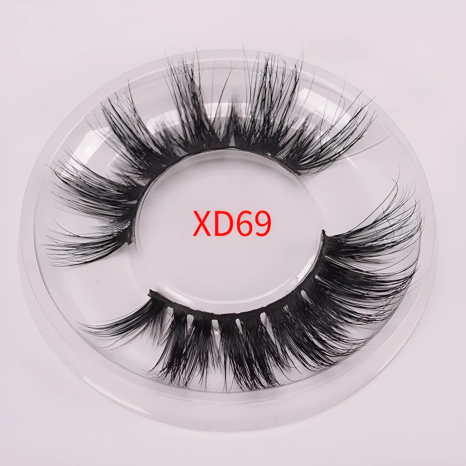 A pair of 5D mink false eyelashes with a hair cap and double-headed brush on a white background.