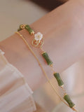 Handcrafted green olivine bracelet with double layer twin bells and olive branch design.