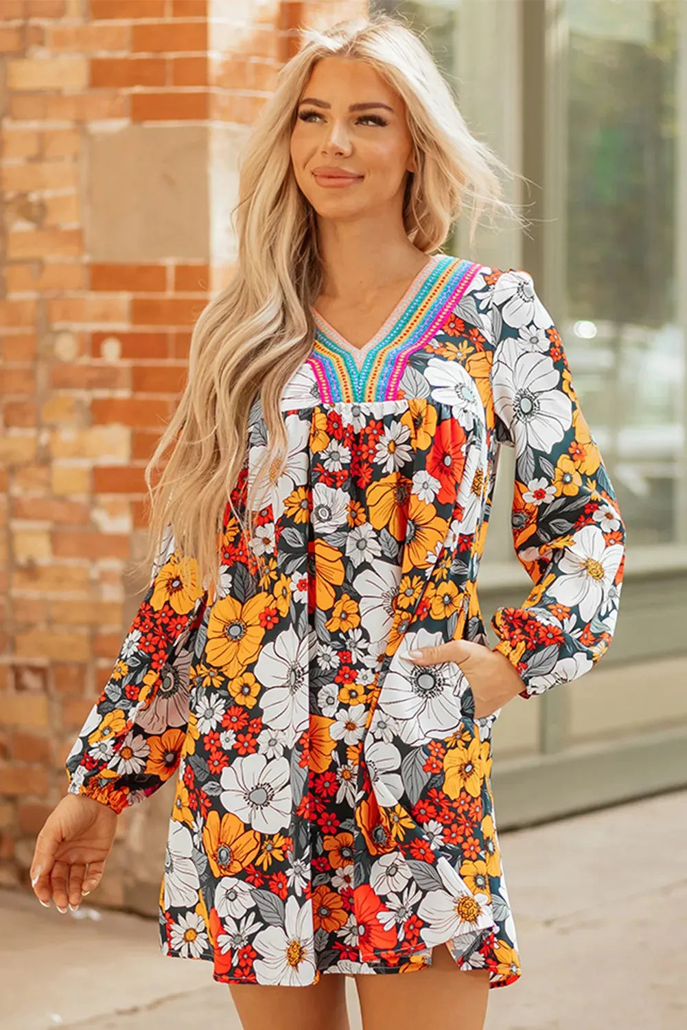 Orange floral stripe bodycon mini dress with V-neck and lace detailing on long sleeves.