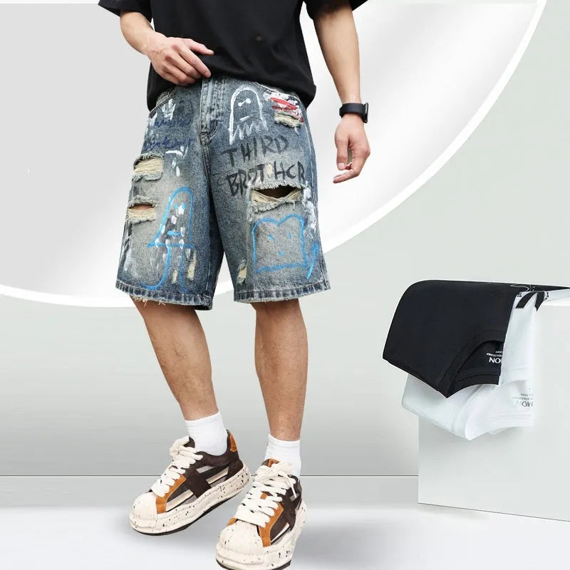 Men's blue ripped jeans shorts with graffiti detail, straight leg cut, and zipper fly closure