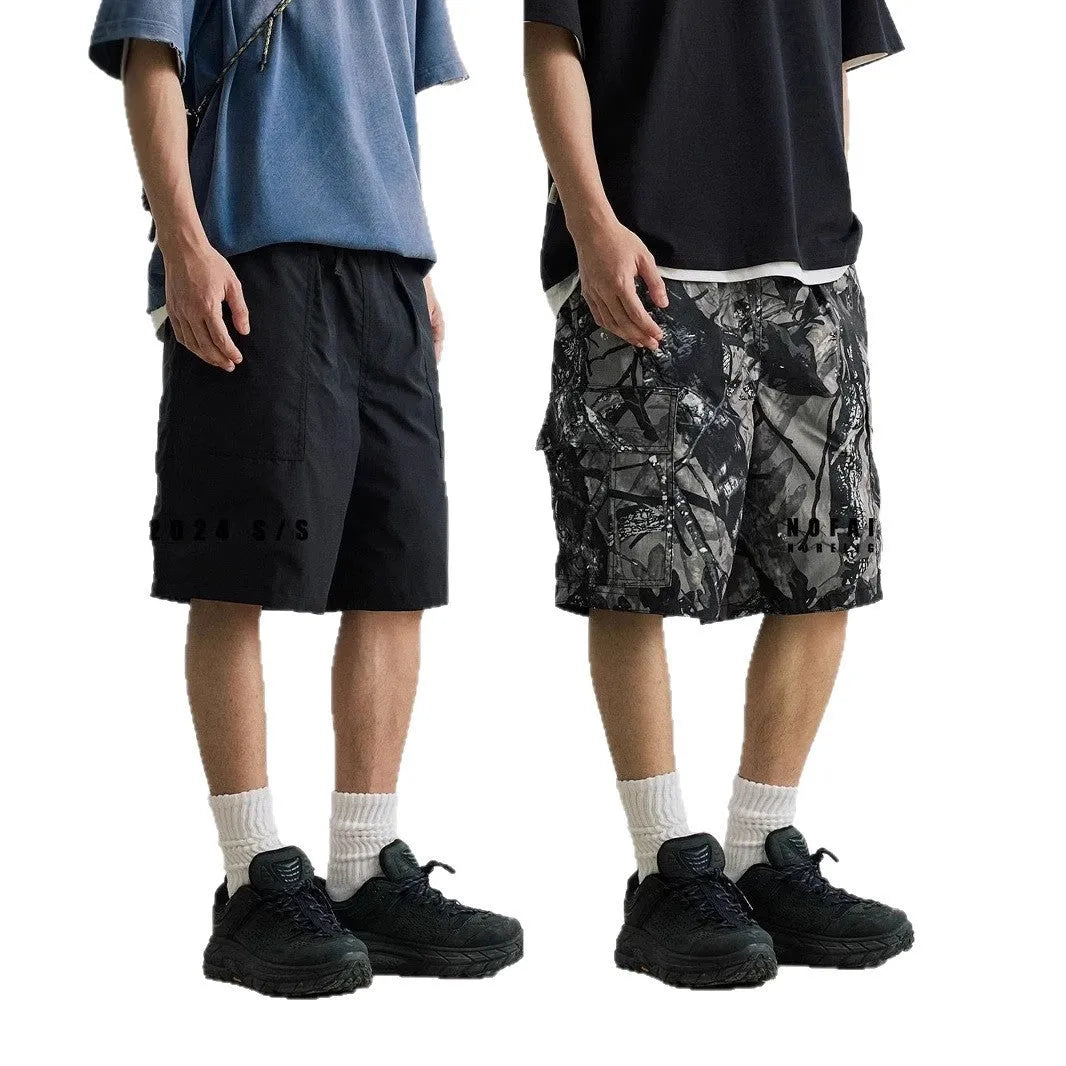 Army green loose fit straight-leg denim shorts with a mid waist and zip fly on a hanger.