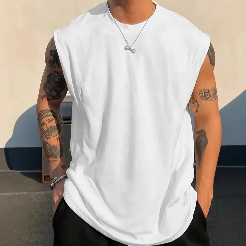 Men's loose fit solid colour cotton sleeveless t-shirt on a hanger, shown in apricot.
