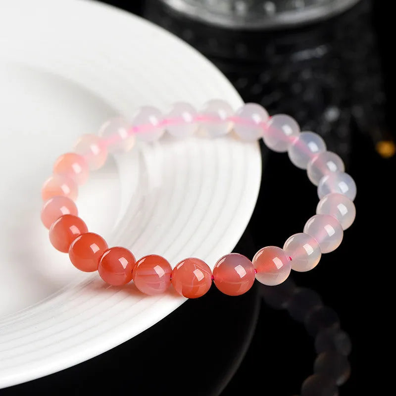 Natural gradient Yanyuan agate bracelet in geometric beads on a wrist.