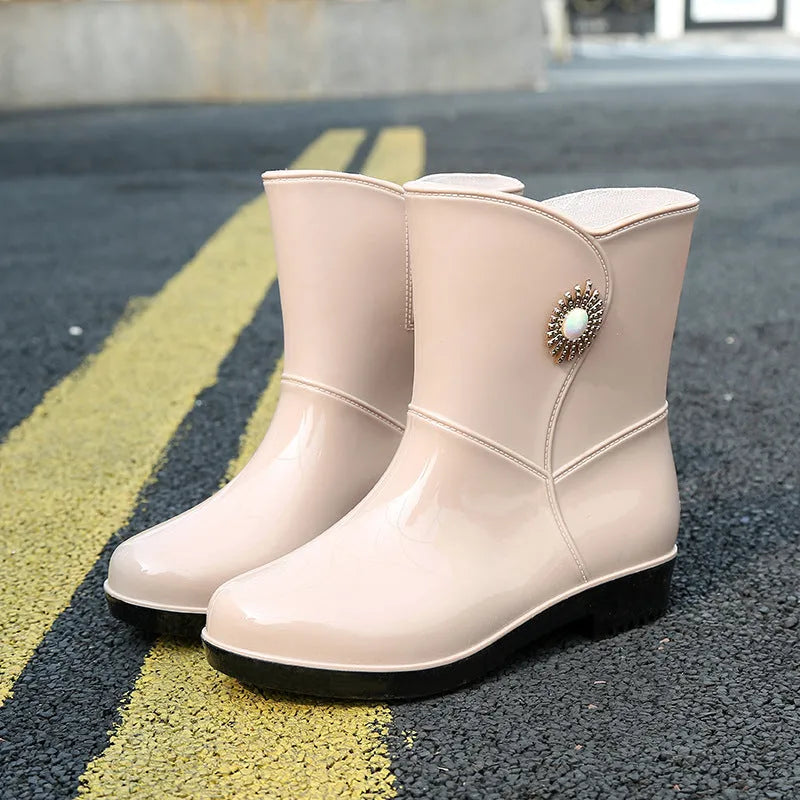 Women's purple PVC rain boots with a middle tube height and textured non-slip sole.