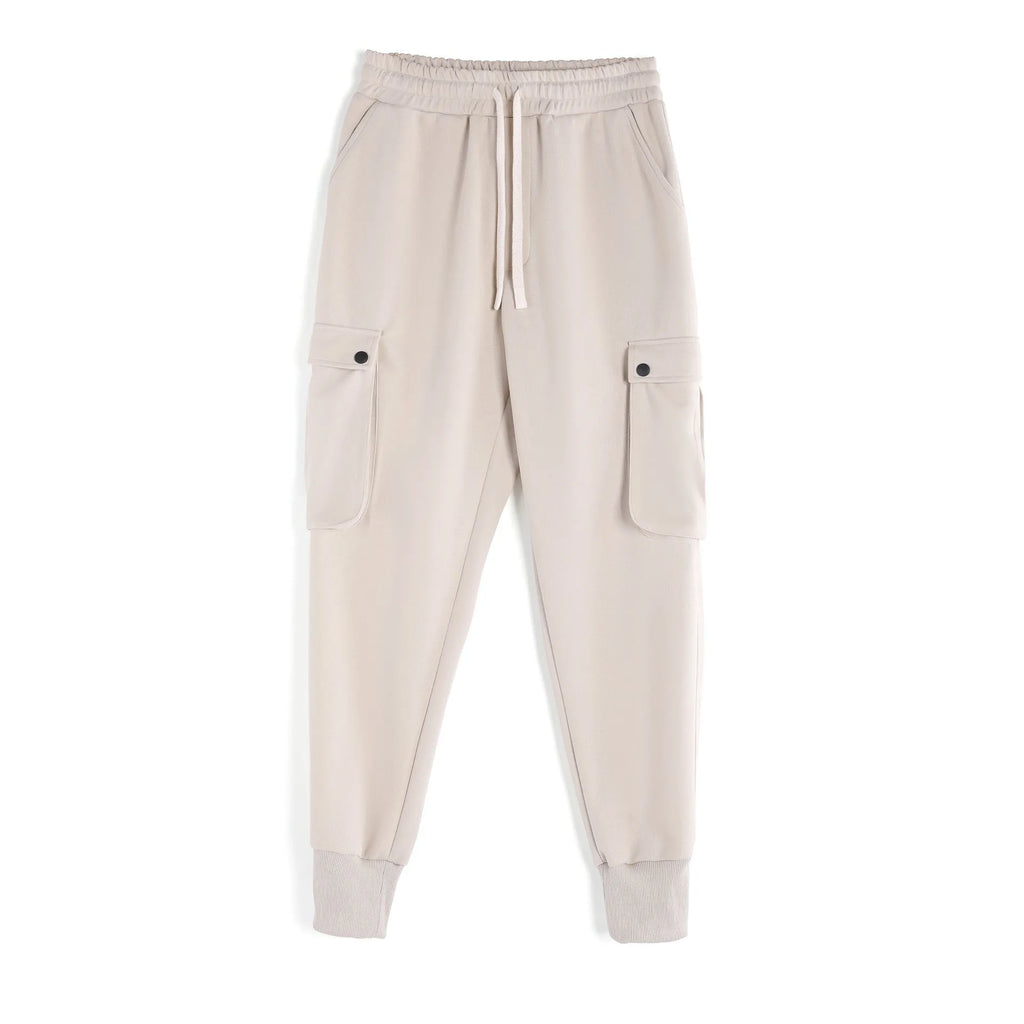Men's loose cotton trousers with ankle ties and multiple pockets in a light grey colour