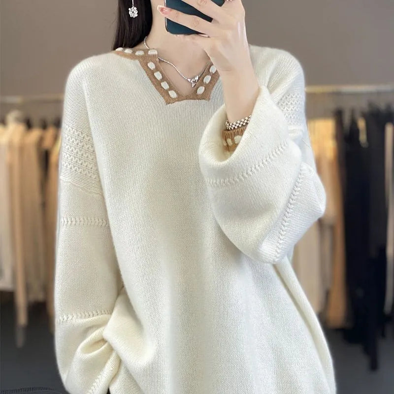 Women's white V-neck long sleeve viscose sweater on a hanger.