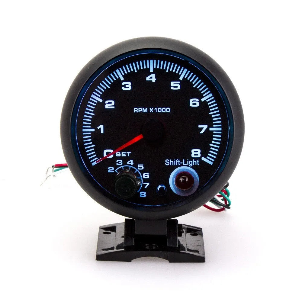 Black automotive tachometer with blue light pointer display showing RPM scale up to 8000.