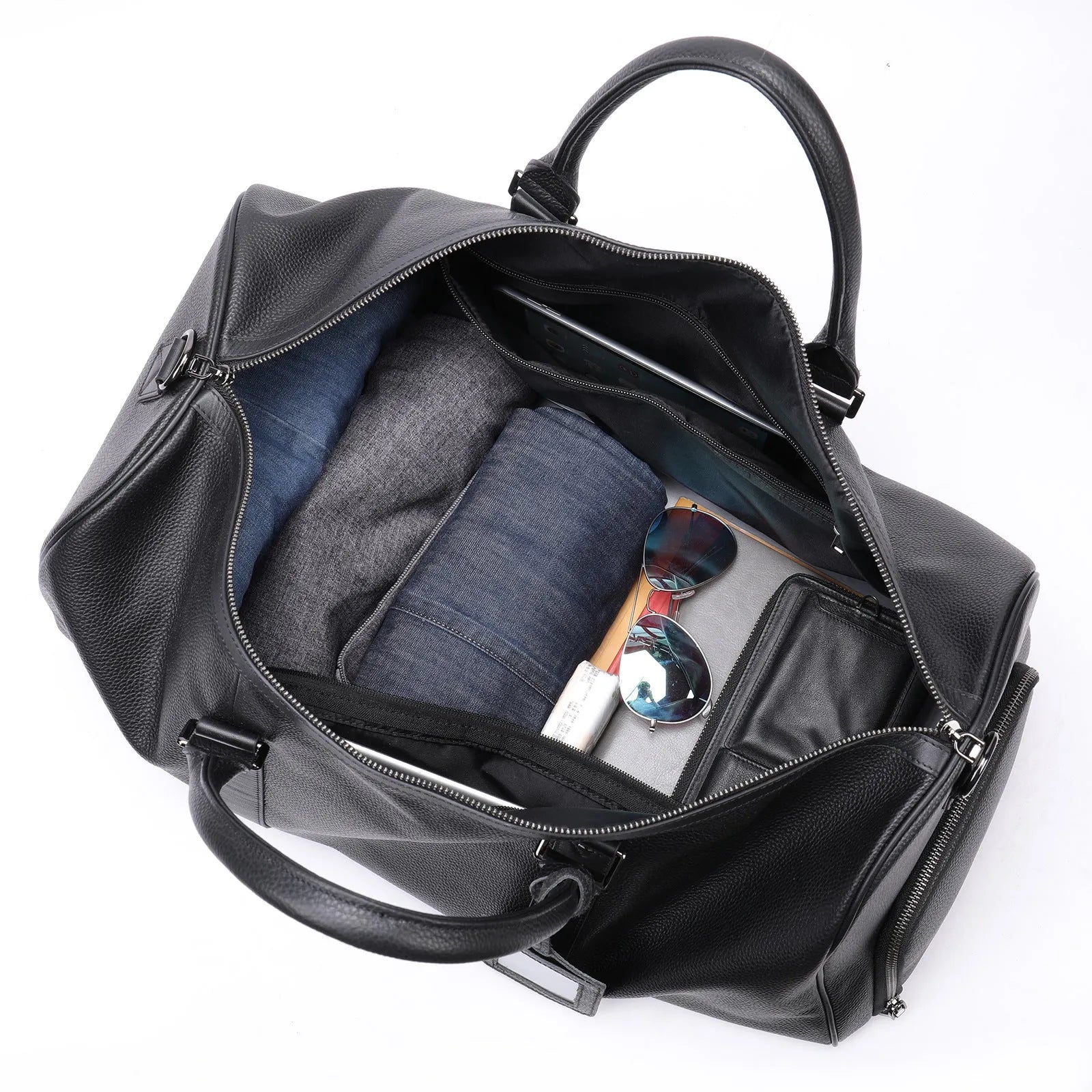 Men's black leather excursion bag with single strap, shown next to coffee colour version