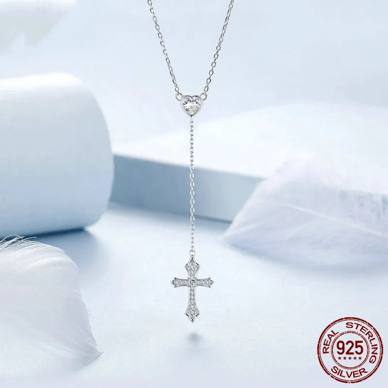 Close-up of a sterling silver V-neck cross pendant on an O-ring chain, colour BSN384.