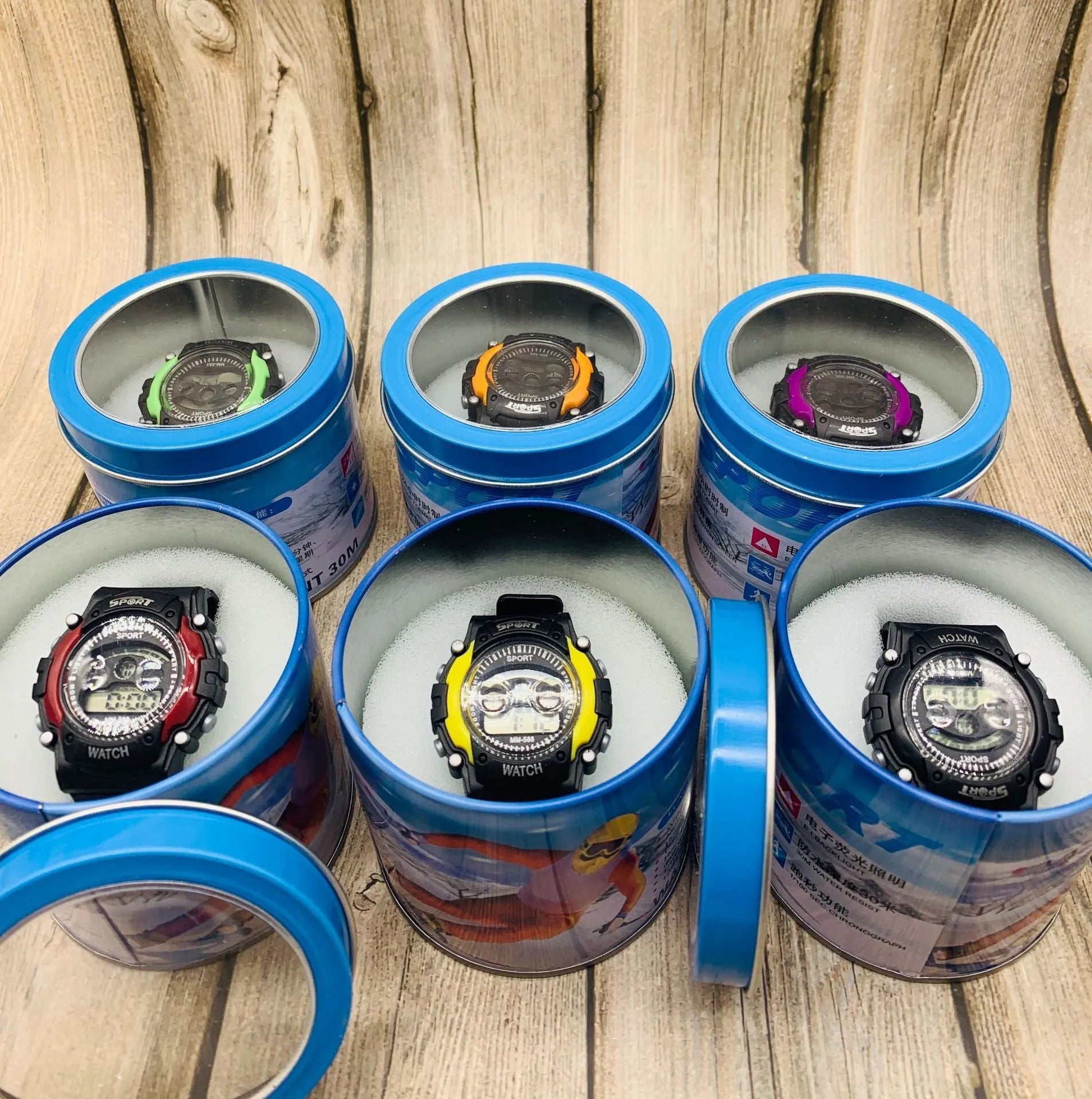 Children's digital sports watch with black plastic case, silicone strap, and luminous display showing time