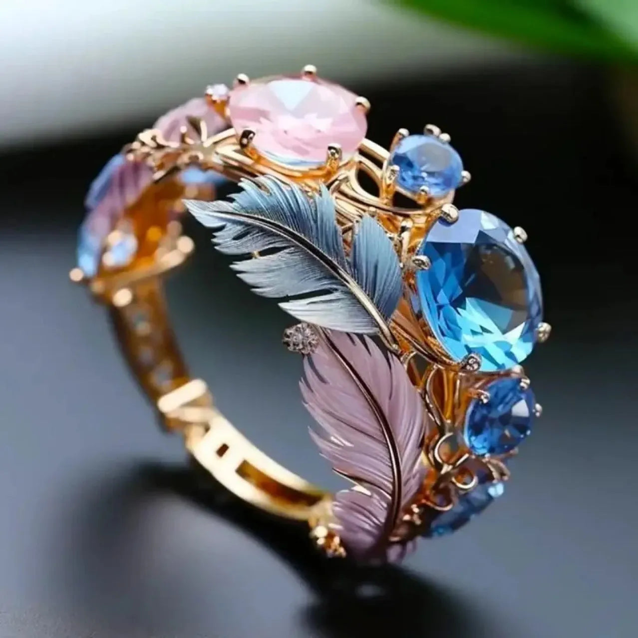Gold colour embossed feather ring with colourful design and geometric shape