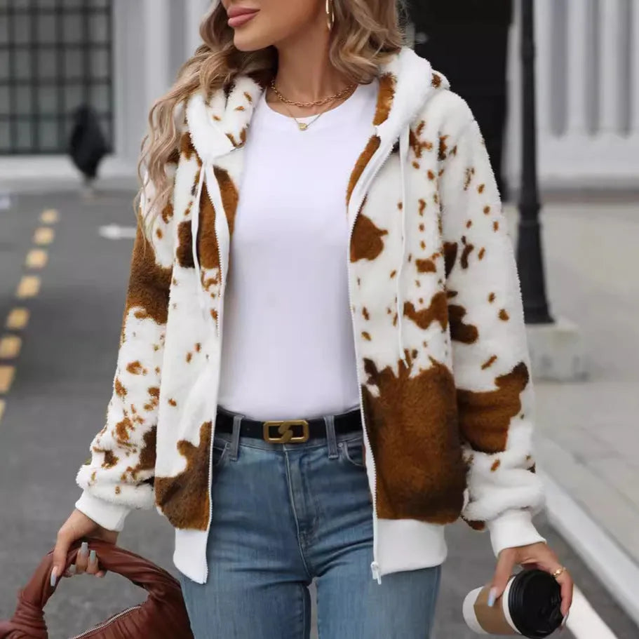 Yellow brown cow animal print hooded cardigan jacket with zip front on a hanger