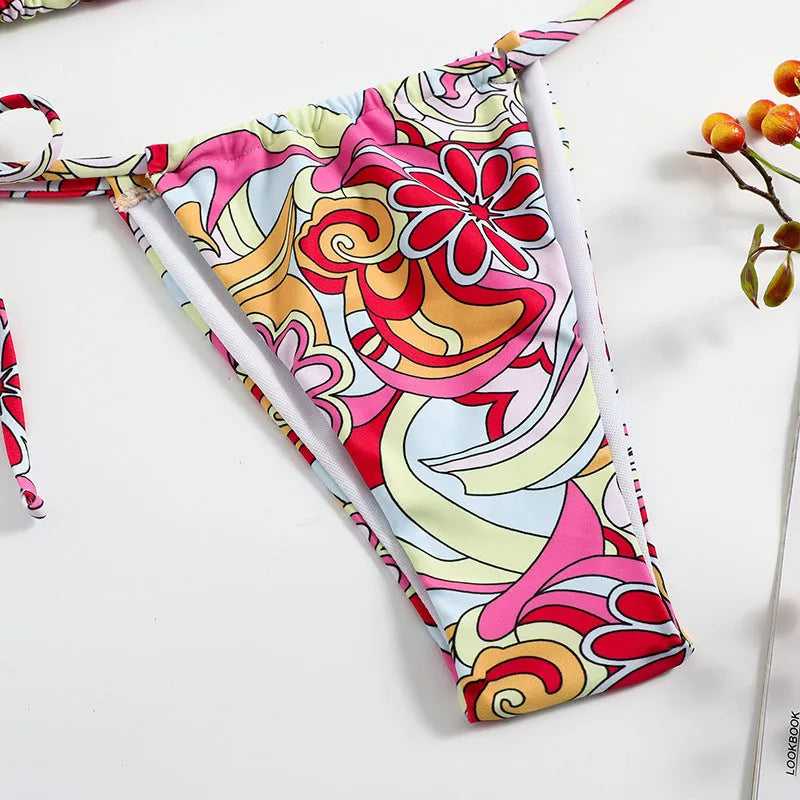 Multicolor printed women's triangle bikini top with hanging neck and matching bottoms.