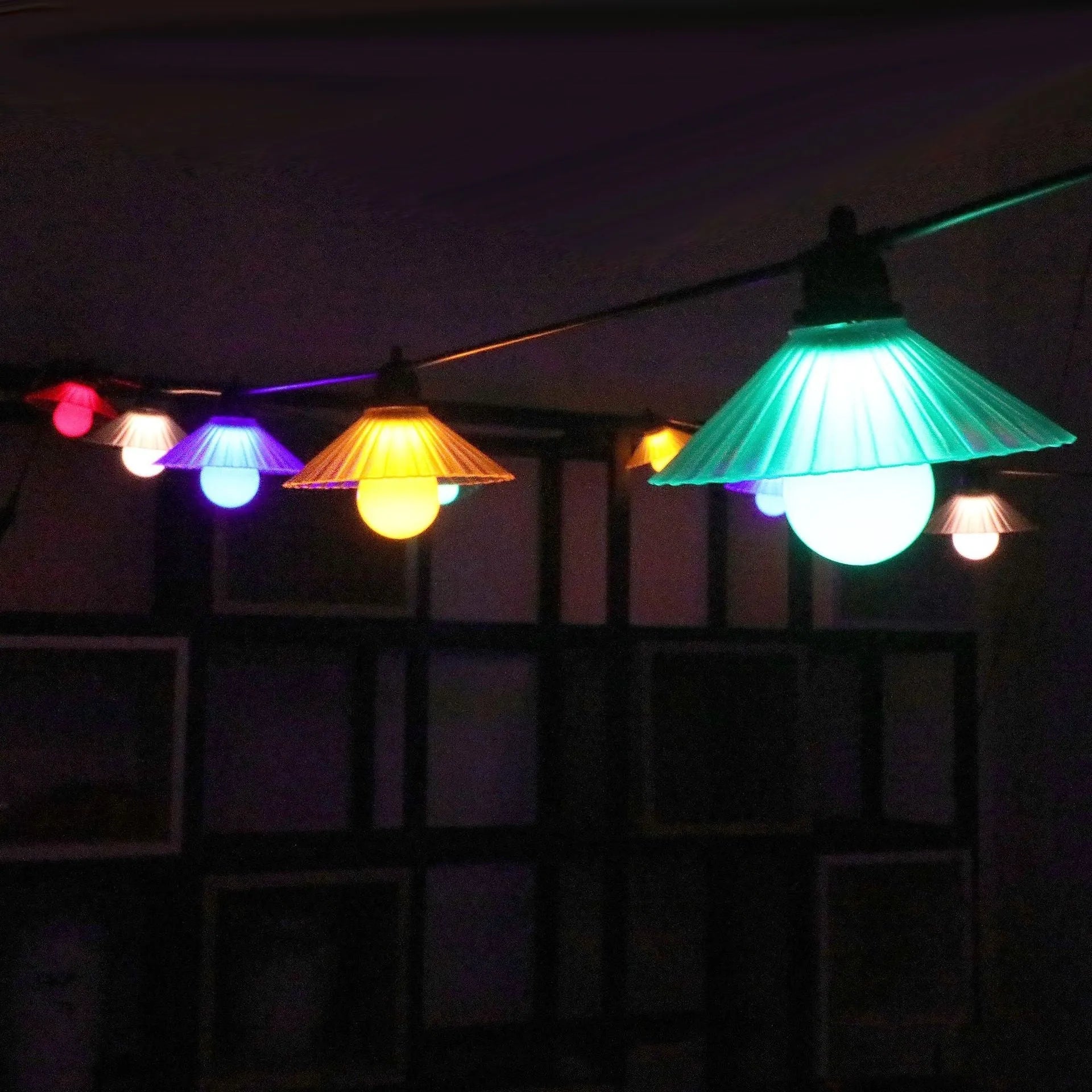 Outdoor LED string lights with flower-shaped bulbs showing IP65 waterproof rating for courtyard and camping use