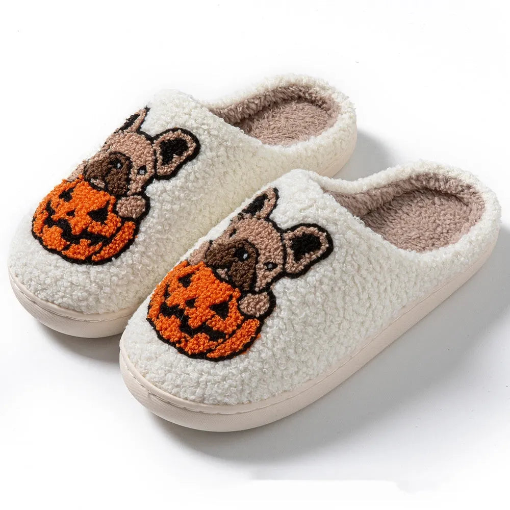 A pair of black and white Halloween-themed plush house slippers with rubber soles.