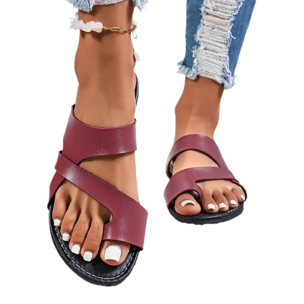 Simple round head beach slippers in black, brown, or wine red with a breathable hollow out design.