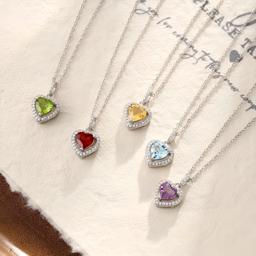 Sterling silver heart necklace with a choice of amethyst, citrine, topaz, olivine, or garnet gemstone on an adjustable chain.