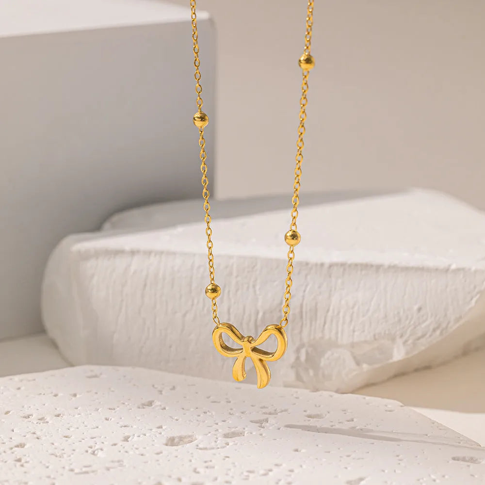 Gold electroplated bow necklace with titanium steel cross chain, adjustable 41-50cm length