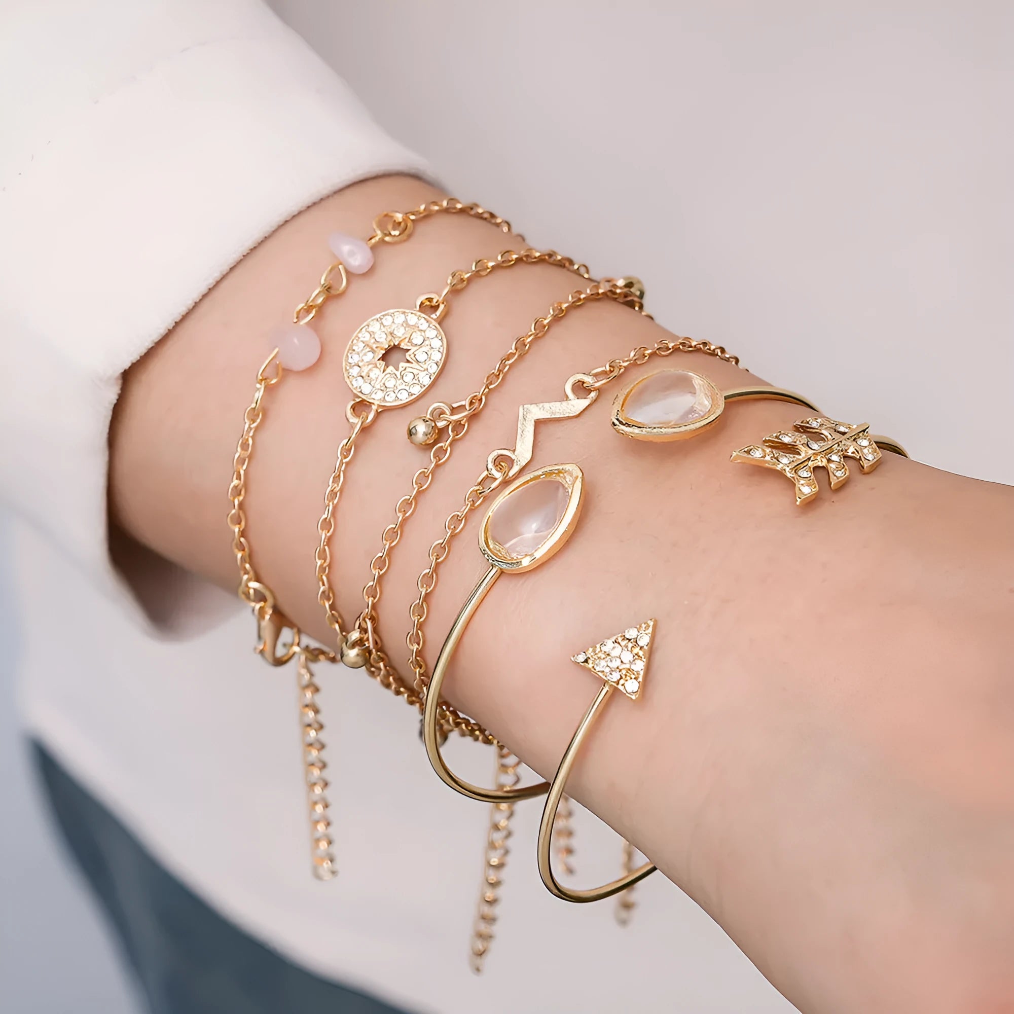 Gold tone six piece women's bracelet set with water droplet and arrow designs