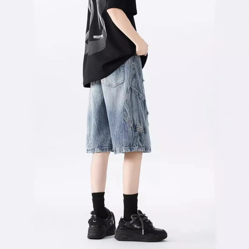 Black and Blue ripped denim shorts with a washed vintage finish and loose, retro fit.