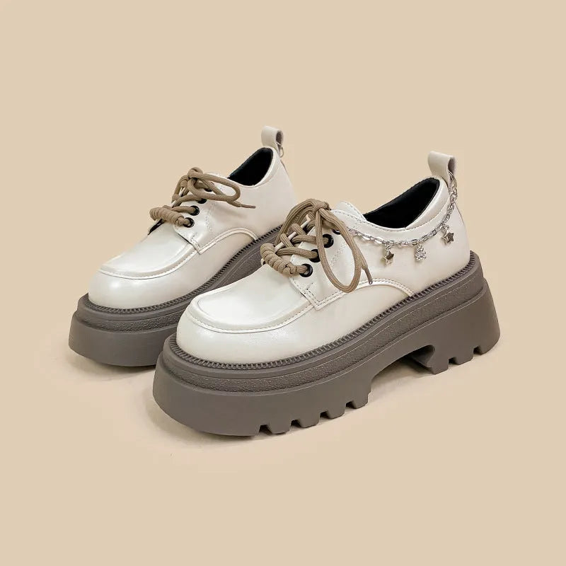 British style white platform leather Mary Jane shoes with chunky heel and lace-up front.