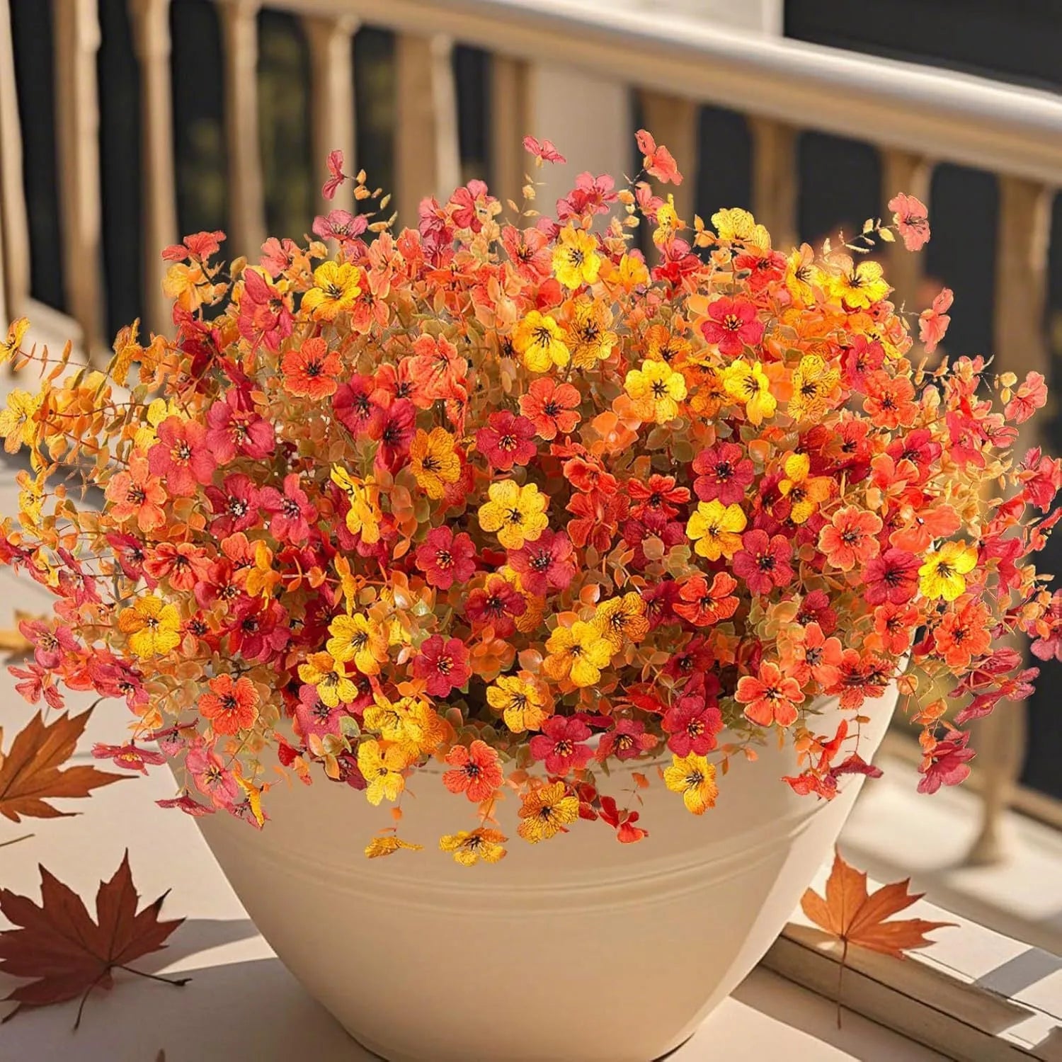 Artificial flower bouquet in autumn colours of red, yellow, orange, and orange yellow for home decoration