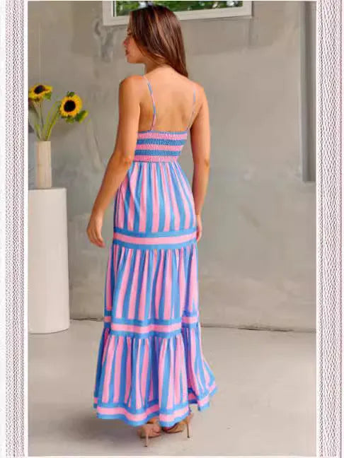 Women's long striped suspender dress with an open back and pockets on a beach