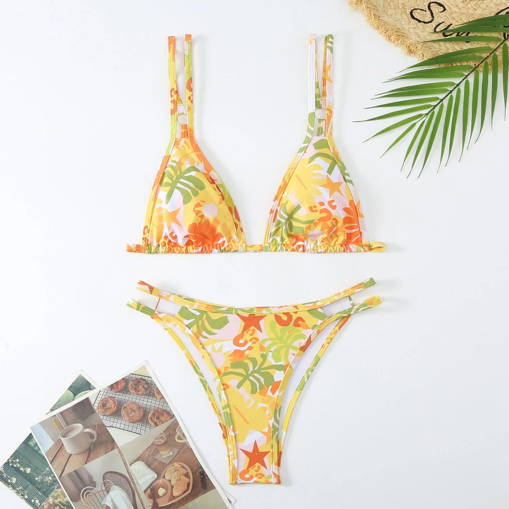 Women's printed halter-neck swim briefs set in blue on a mannequin