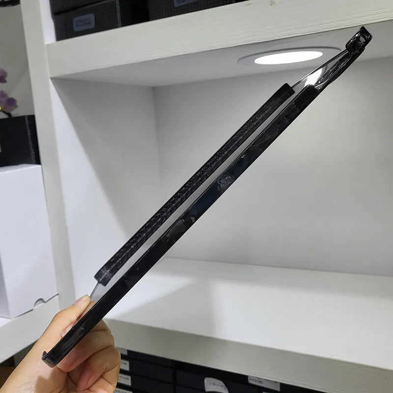 Apple iPad Pro 11 hard case made of black carbon fibre with an embossed plaid pattern.