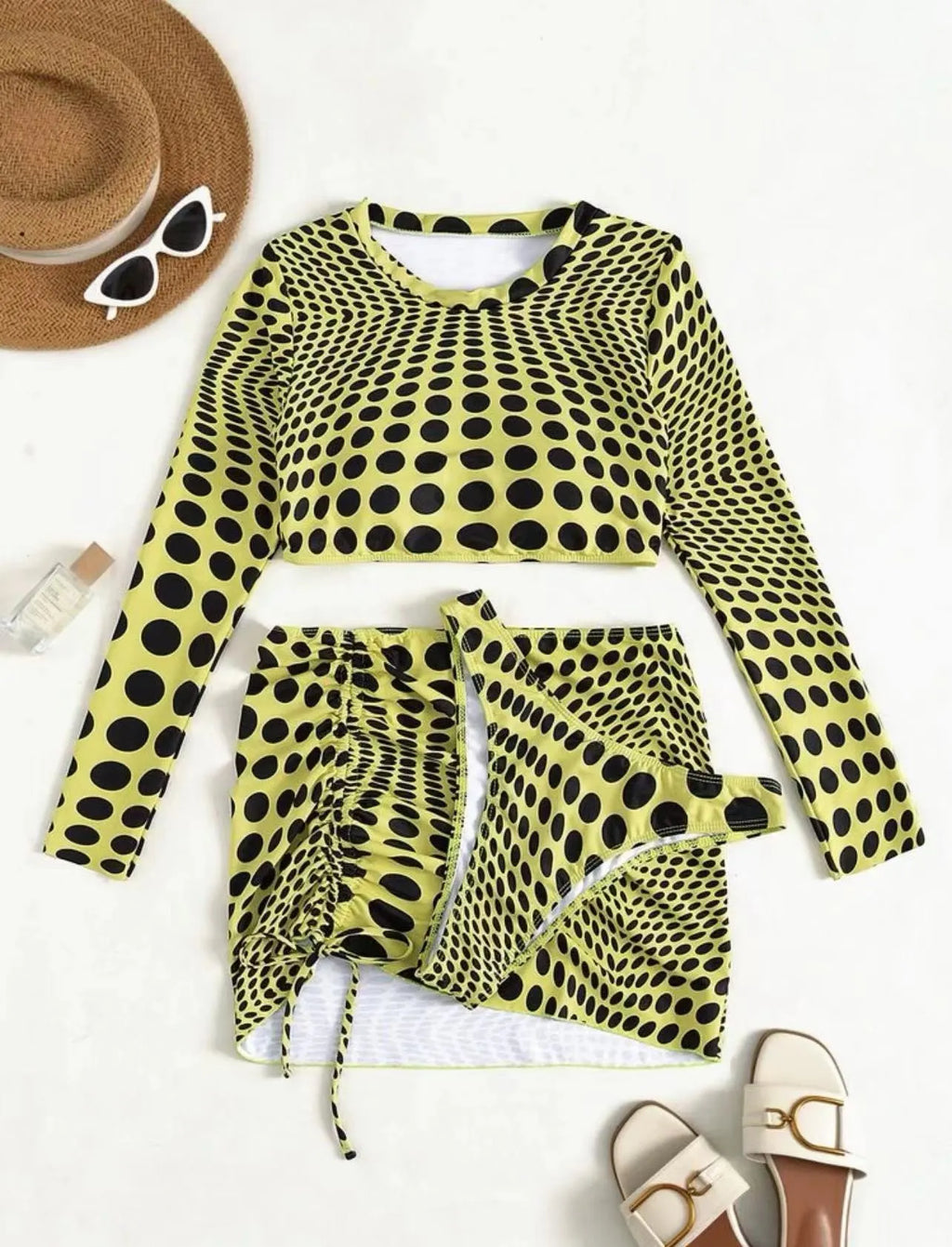 Green and yellow polka dot women's swimsuit three-piece set including top, skirt, and bra.