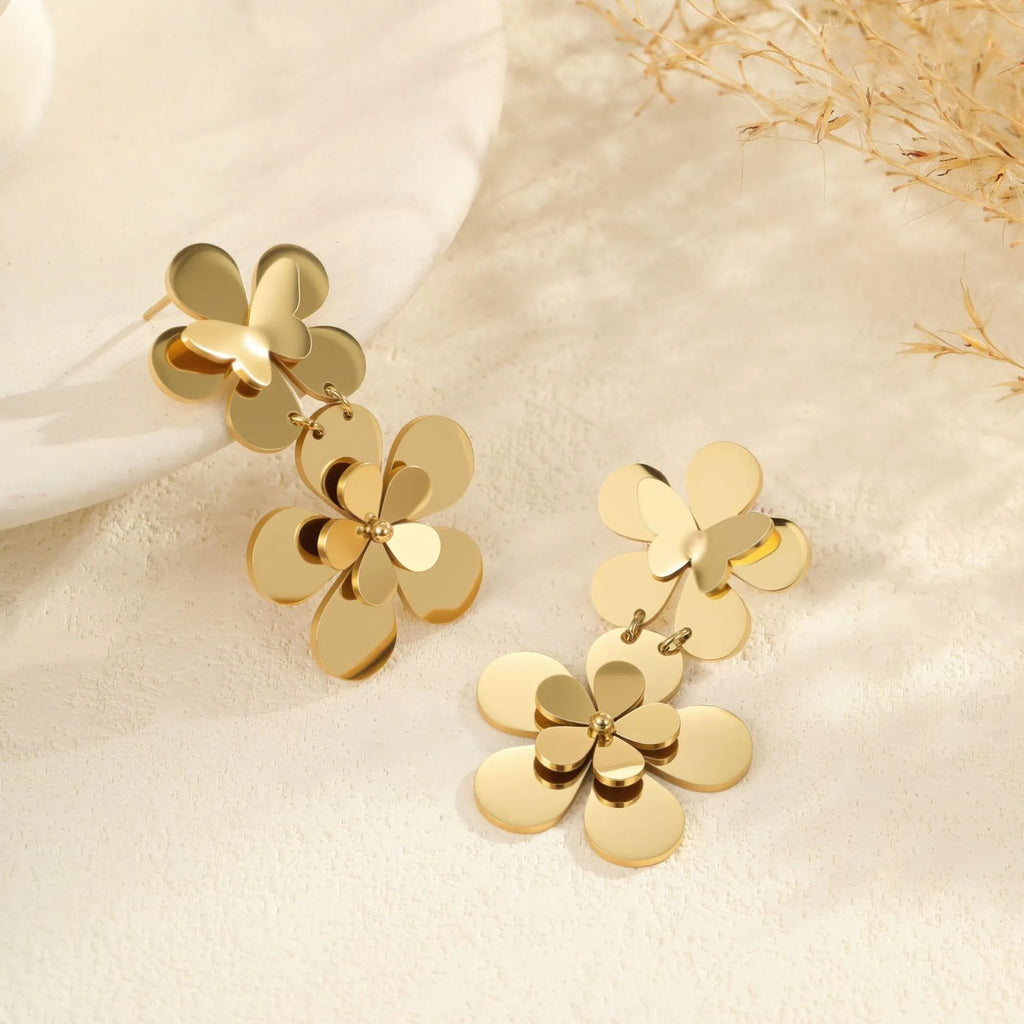 Gold coloured flower butterfly earrings with geometric and zodiac details on stainless steel.