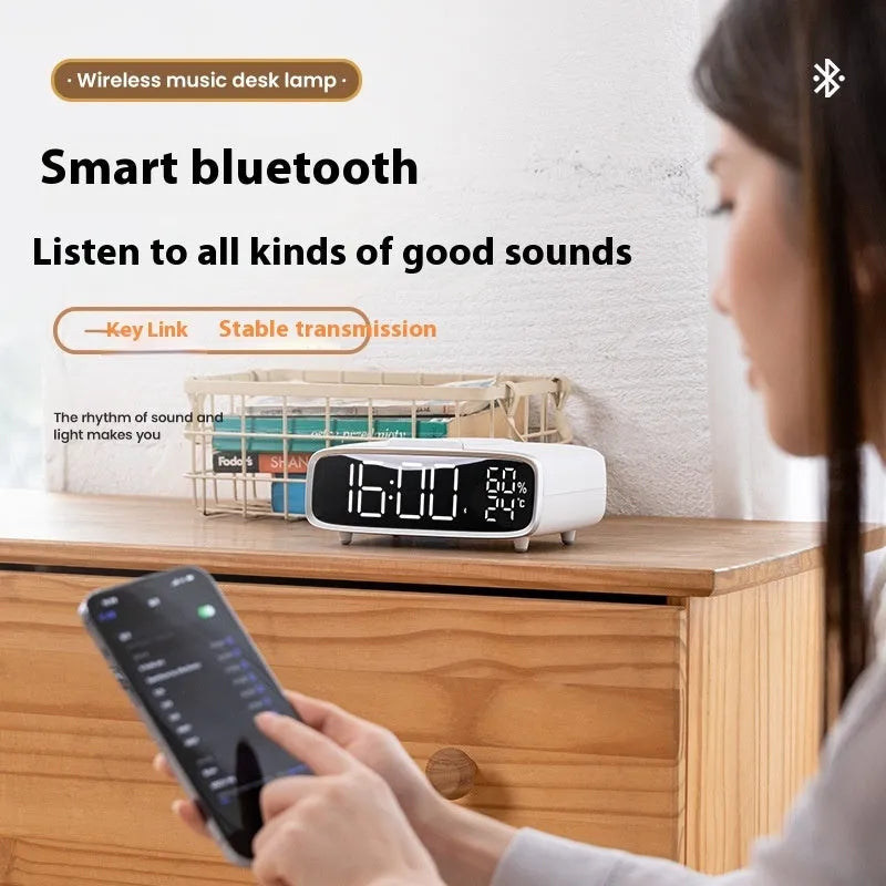 White 3-in-1 bedside unit with wireless charging pad, Bluetooth speaker, and night light.