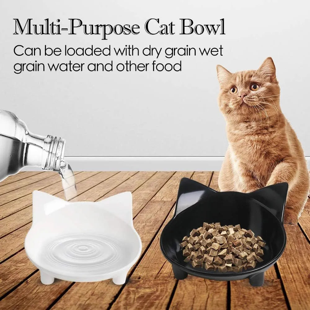 Four shallow black melamine pet bowls with non-slip rubber bases on a table.