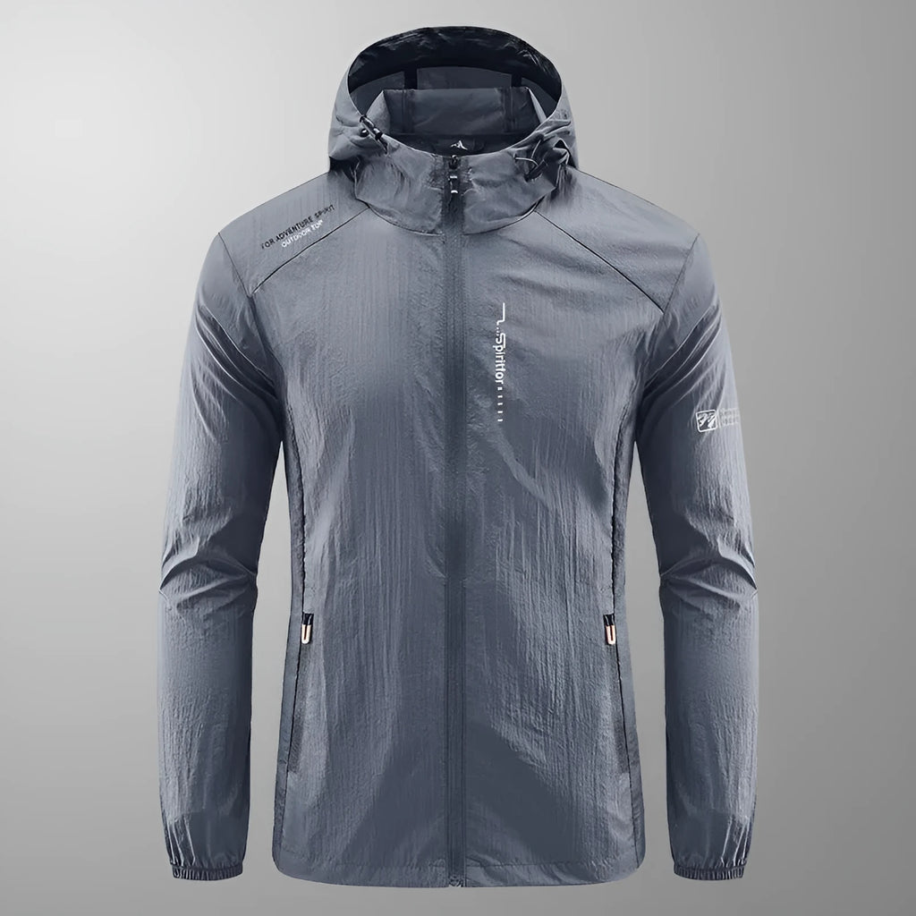 Man wearing a lightweight grey hooded summer jacket made from thin nylon fabric.