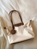 Oxford cloth tote shoulder bag in beige colour showing internal mobile phone pocket and sandwich pocket design