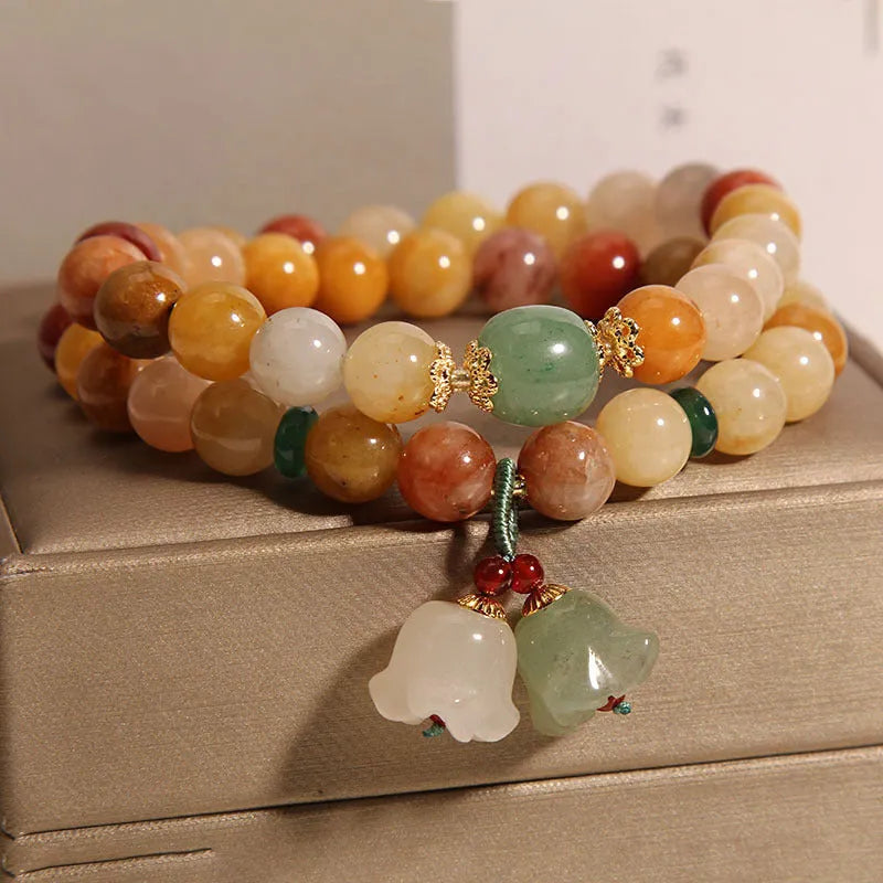Dark green natural jinsi jade multi-layer bracelet with orchid pendant and adjustable sliding knot clasp.