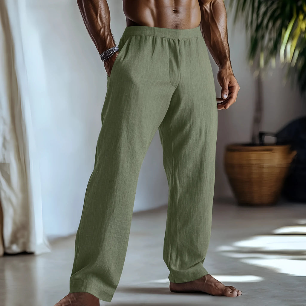 Straight leg casual trousers in cotton and linen fabric in a light green colour, shown with side pockets.