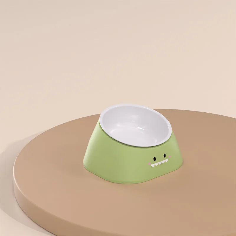 Green tilted stainless steel cat bowl with non-slip white base at a 15 degree angle