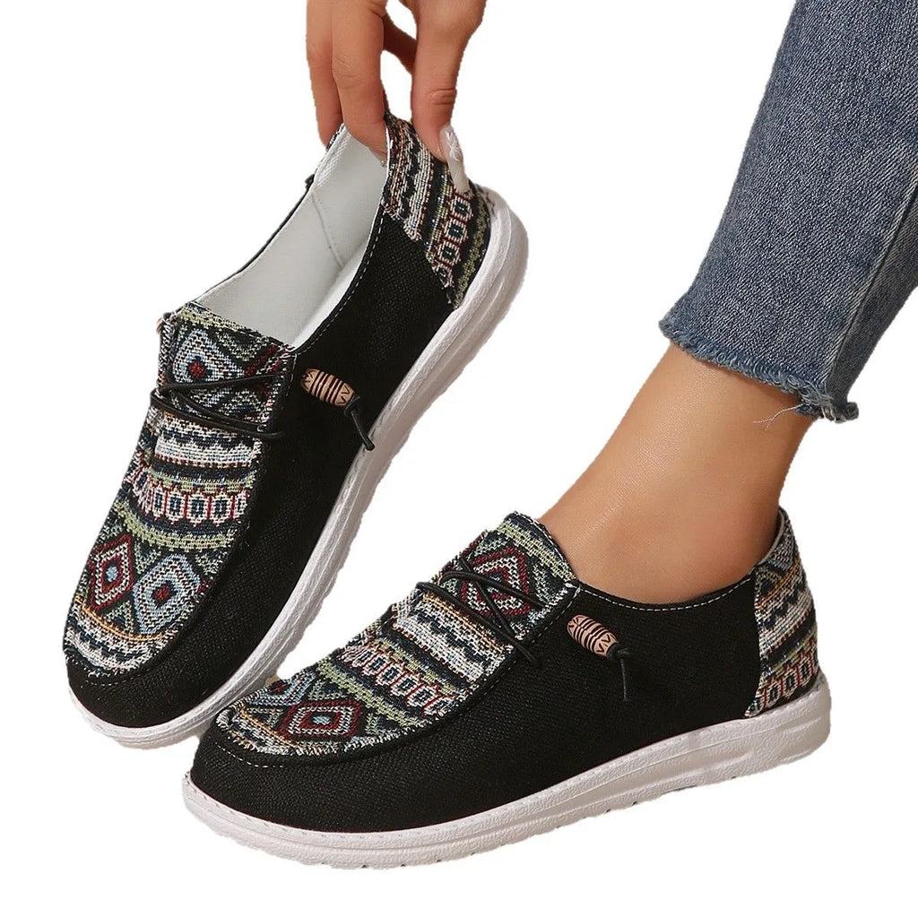Women's black flat round toe low-top shoes with an oversleeve design on a white background.