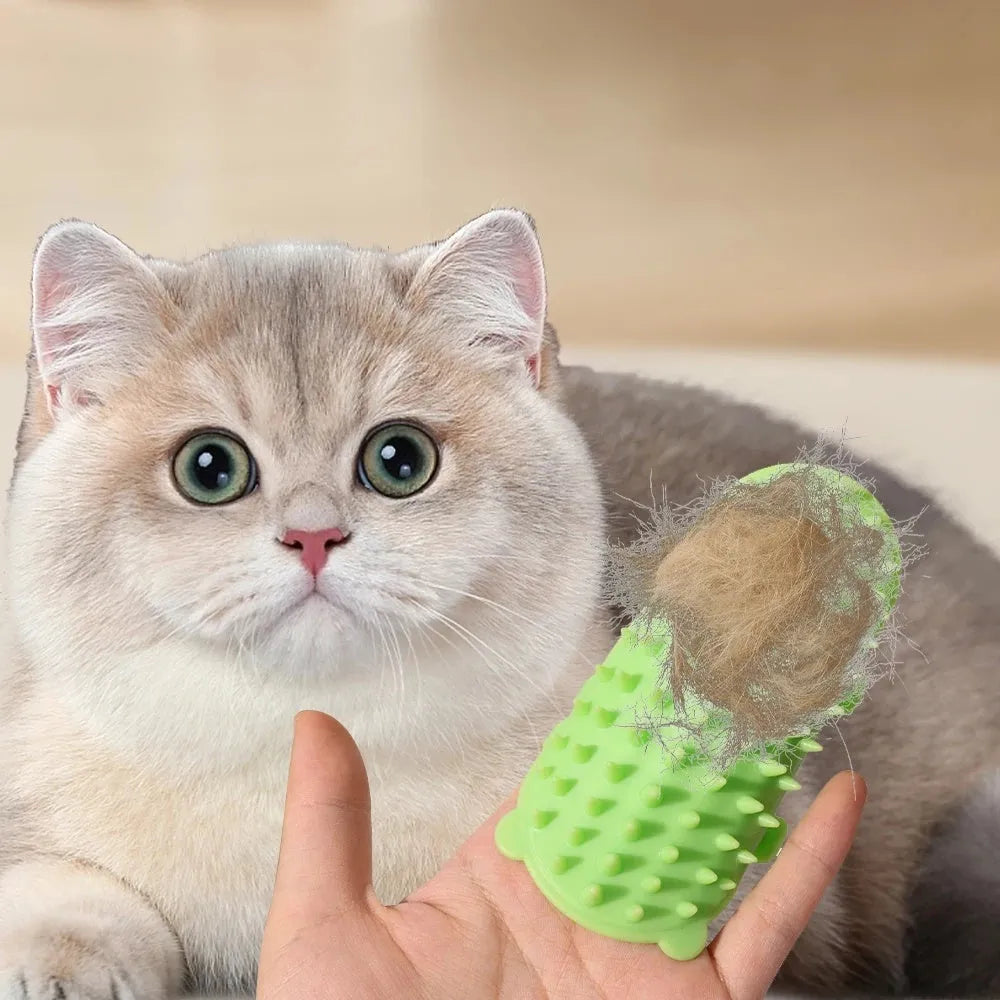 Silicone cat grooming comb with adjustable strap mounted on a table leg, shown in yellow.