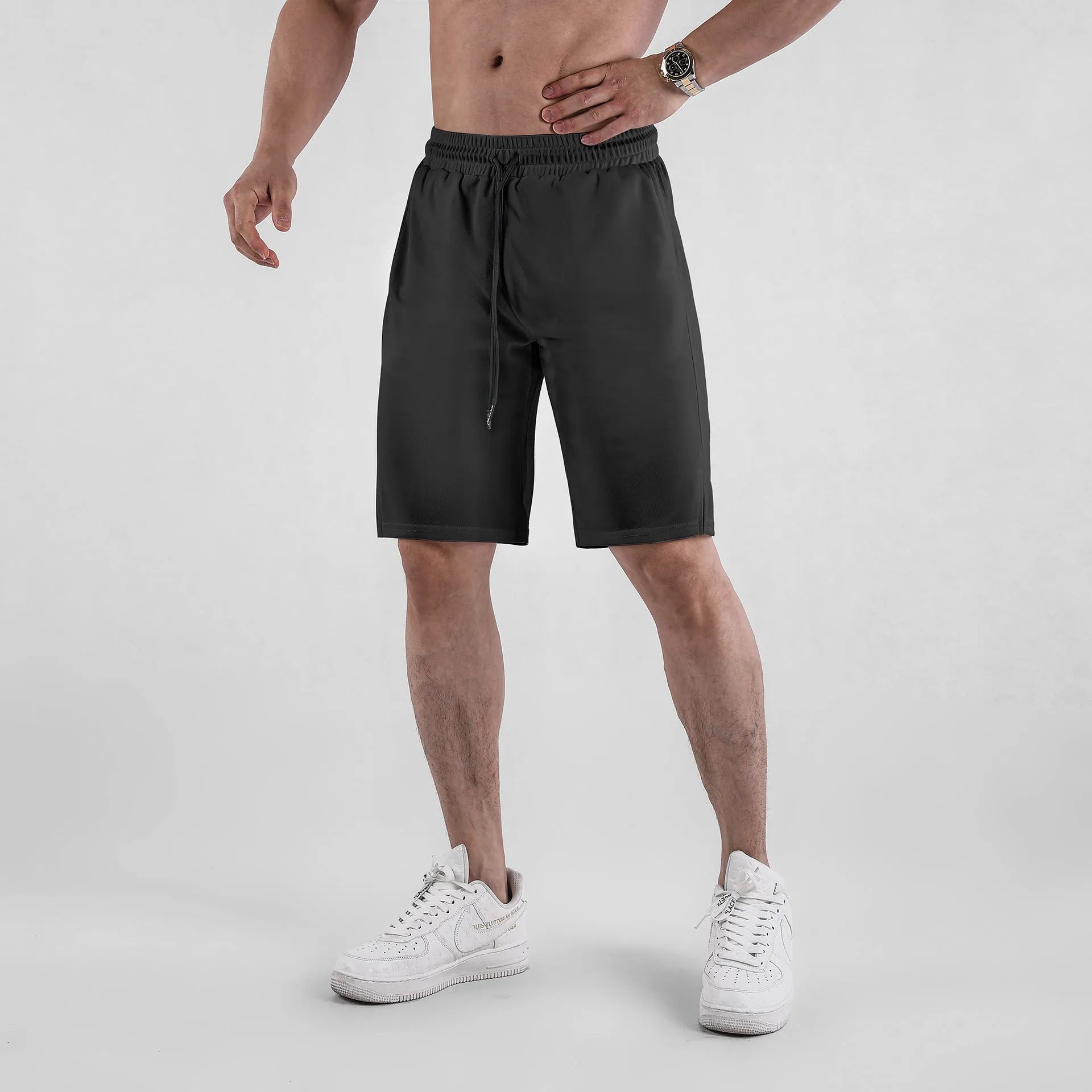 Men's black and white quick-drying loose-fit mesh shorts with elastic waistband.