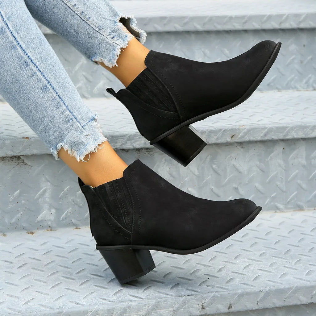 Women's black pointed toe ankle boots with thick square low heel and slip-on design