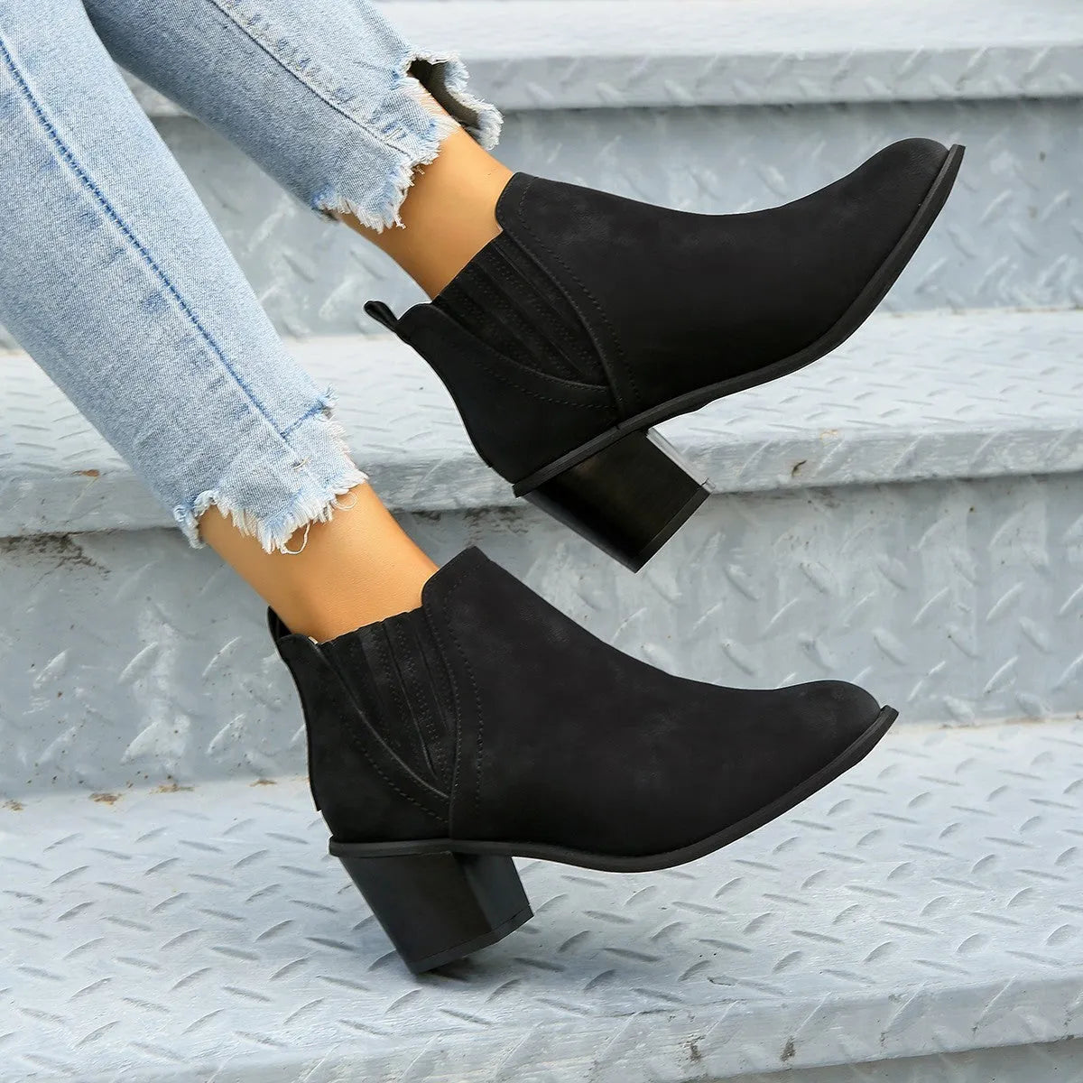 Women's black pointed toe ankle boots with thick square low heel and slip-on design