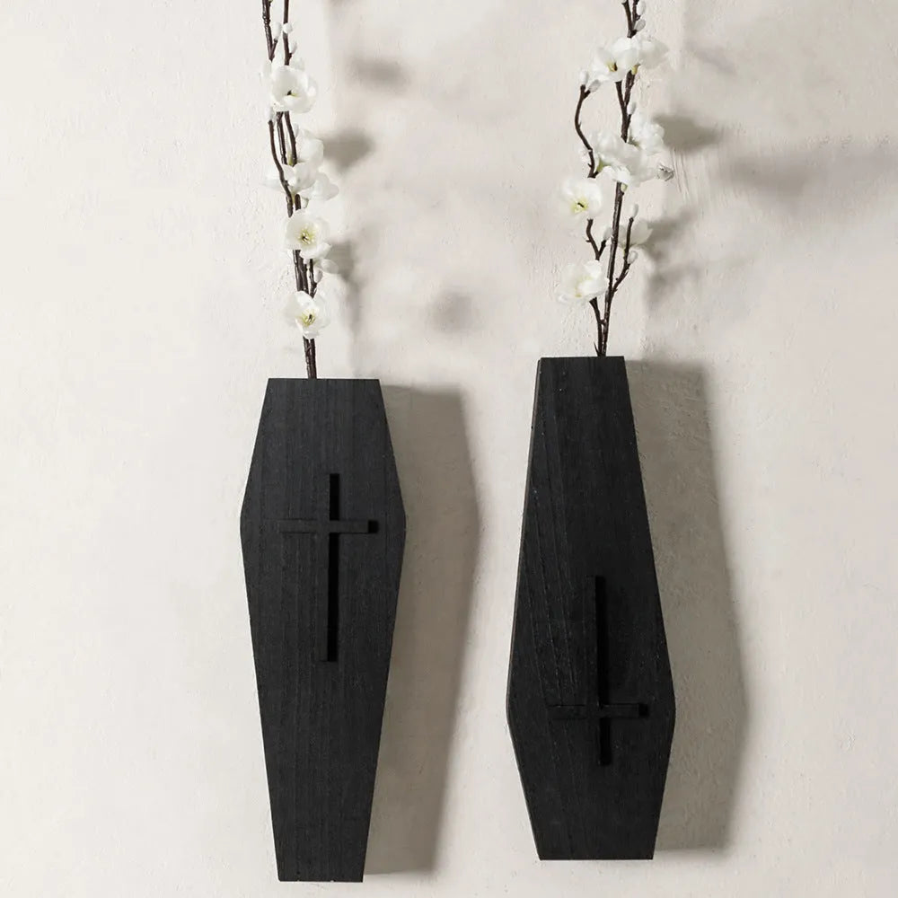 Black wooden cross wall shelf decoration measuring 27 cm by 9 cm.