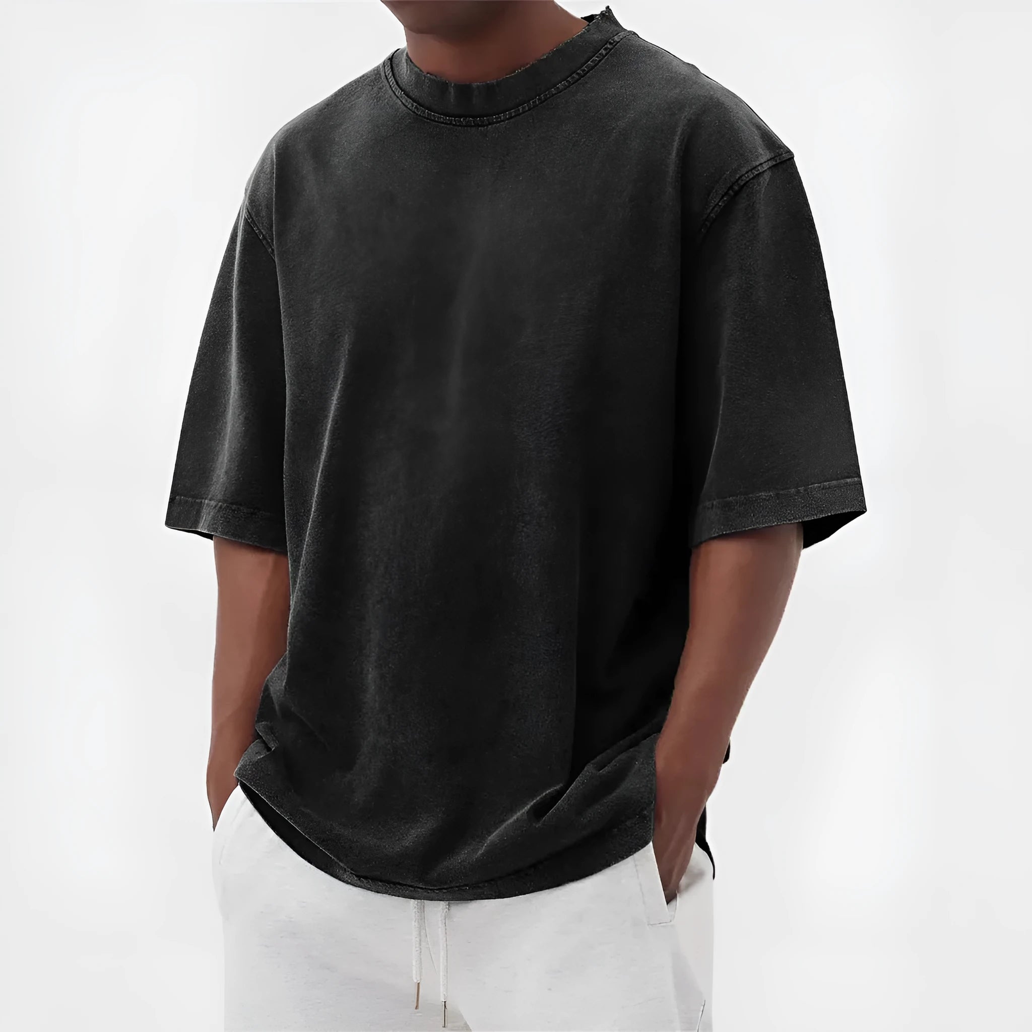 Man wearing a loose-fit, stone-washed distressed men's short sleeve T-shirt in a solid colour.
